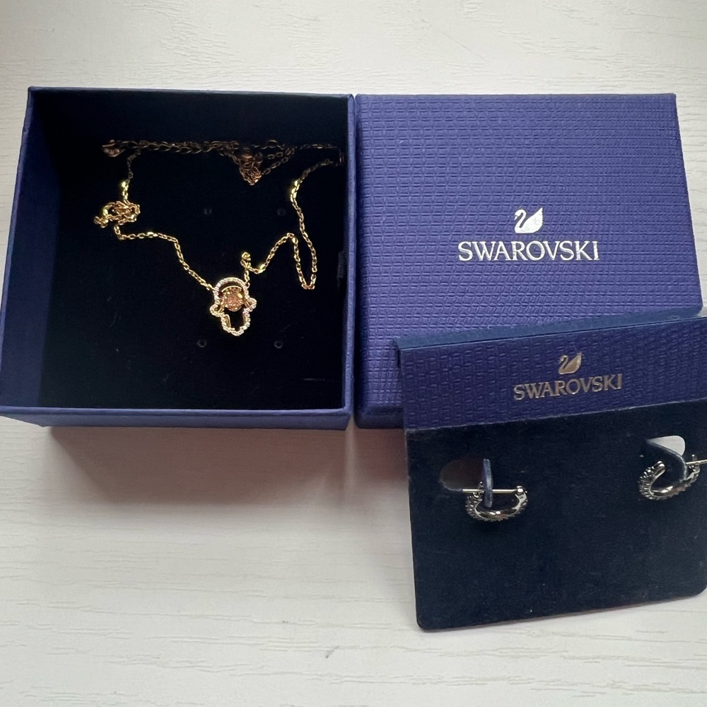 Swarovski hamsa necklace and black onyx huggie earrings.
